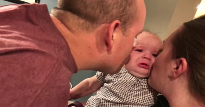  Little tiny baby doesn’t want dad to kiss mom, his reaction is very touching
